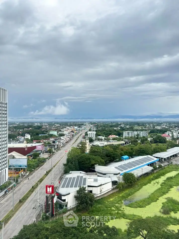 Stunning cityscape view from high-rise building with lush greenery and expansive skyline.