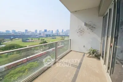 Spacious balcony with stunning city skyline view, perfect for relaxation and enjoying urban living.