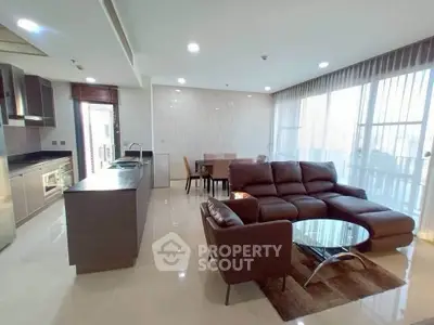 Spacious open-layout living room with modern kitchen and large windows in a luxury apartment.