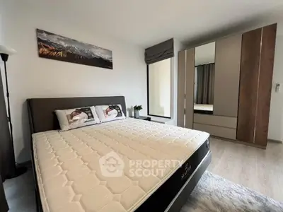 Spacious modern bedroom with stylish decor and large wardrobe