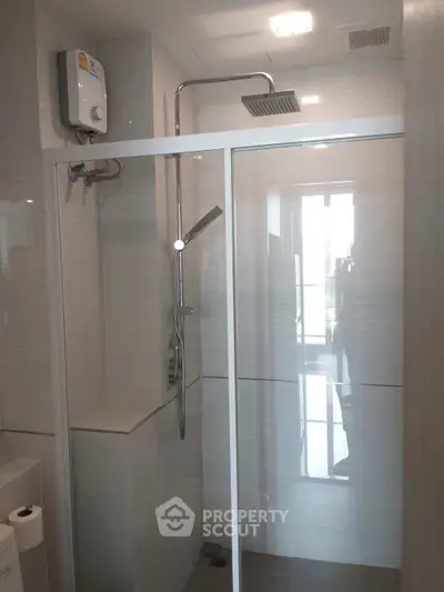 Modern bathroom with glass shower enclosure and sleek fixtures