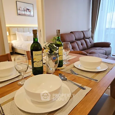 Elegant dining setup in modern living room with cozy sofa and bedroom view