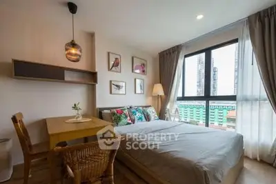 Cozy bedroom with large window and stylish decor in urban apartment