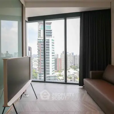 Modern living room with floor-to-ceiling windows offering stunning city views.