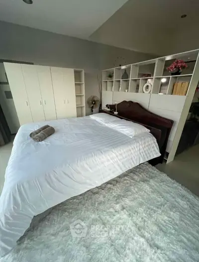 Spacious bedroom with elegant decor and ample storage space