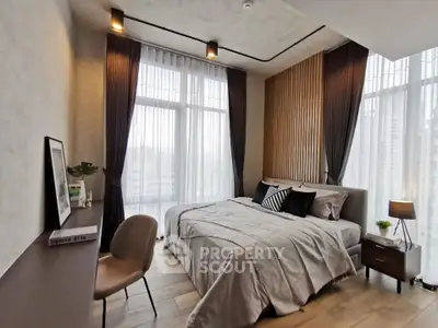 Modern bedroom with large windows, stylish decor, and cozy ambiance in a high-rise apartment.