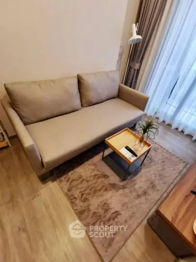 Cozy living room with modern beige sofa and stylish decor