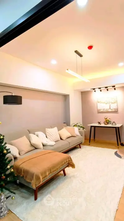 Modern living room with cozy sofa, elegant lighting, and stylish decor in a contemporary apartment.