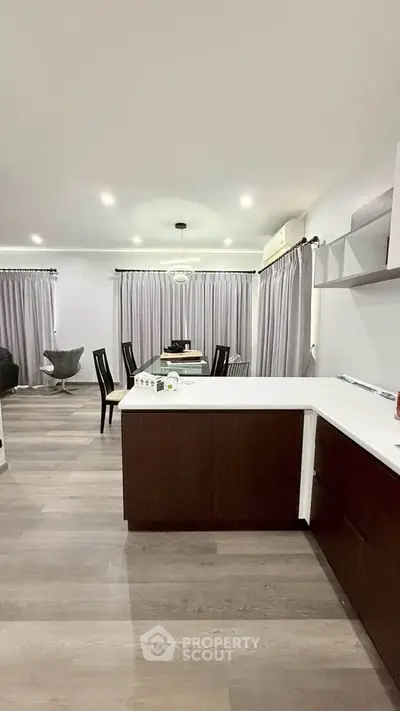 Modern open-layout kitchen and dining area with sleek design and ample natural light.