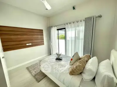 Cozy bedroom with modern decor and large window for natural light