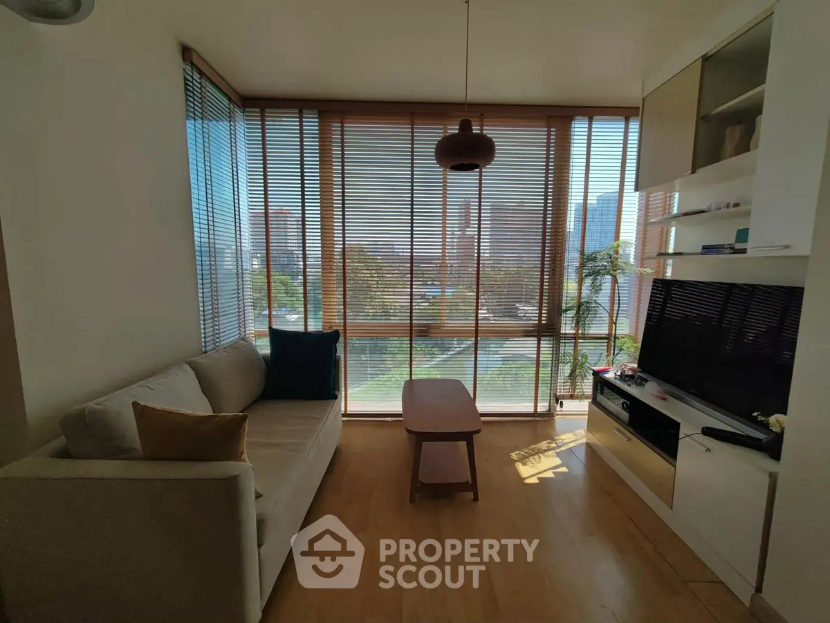 Modern living room with large windows and stylish decor in urban apartment