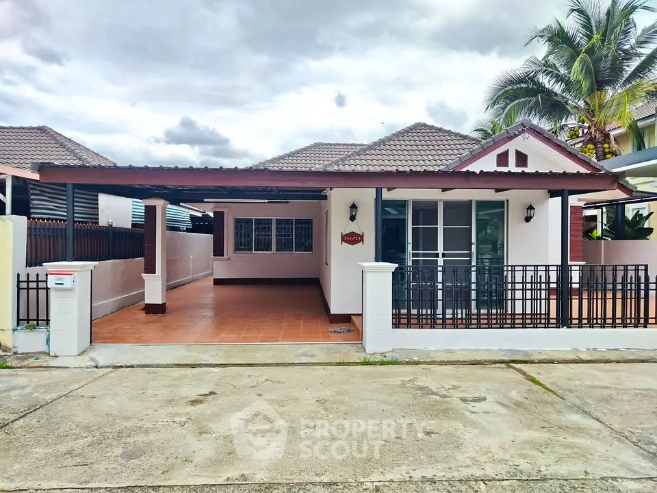 Charming single-story home with spacious driveway and tiled patio, perfect for family living.