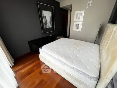 Modern bedroom with hardwood floors and stylish decor