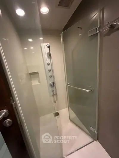 Modern bathroom with glass shower enclosure and sleek fixtures