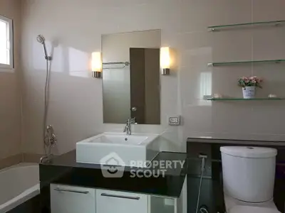 Modern bathroom with sleek fixtures and elegant design, featuring a bathtub and stylish lighting.