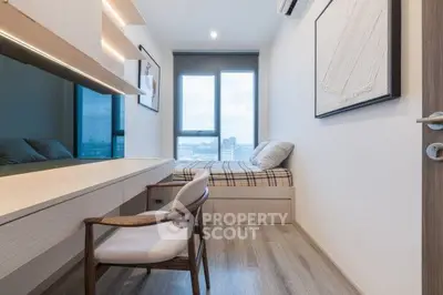 Modern bedroom with sleek design, featuring a built-in desk and large window for natural light.