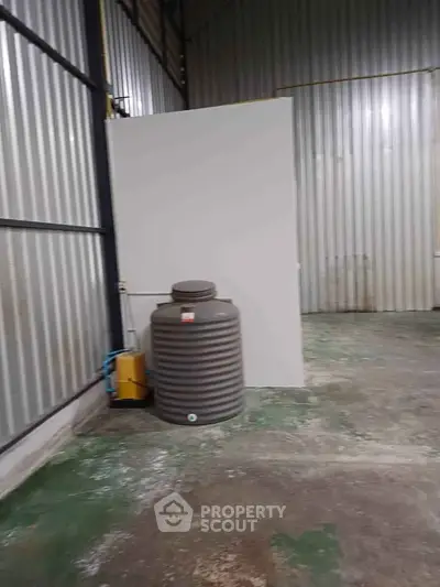 Industrial warehouse interior with metal walls and water tank