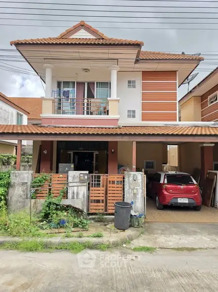 Charming two-story house with carport and balcony in a suburban neighborhood, perfect for family living.