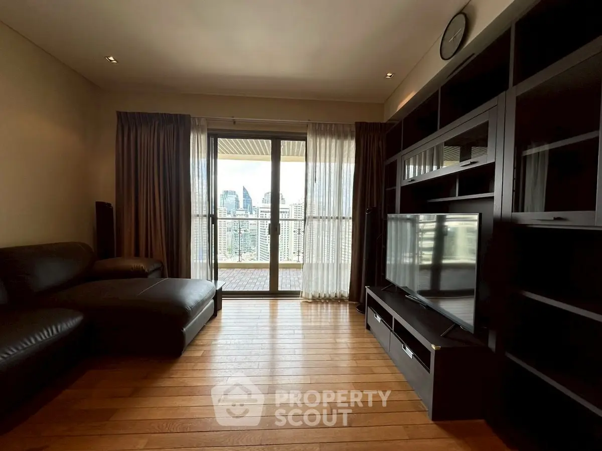 Spacious living room with city view and modern furnishings
