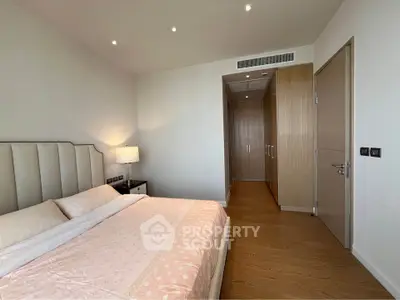 Spacious modern bedroom with elegant decor and ample natural light