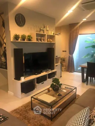 Modern living room with stylish decor and large TV unit