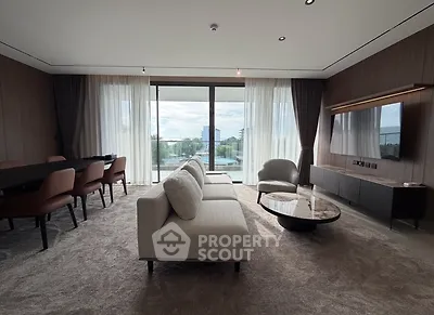 Luxurious modern living room with elegant furniture and large windows offering stunning views.