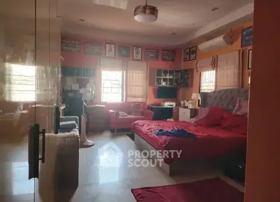 Spacious bedroom with modern decor and ample natural light.