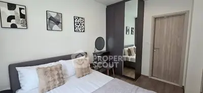 Modern bedroom with stylish decor and mirrored wardrobe in a cozy apartment.