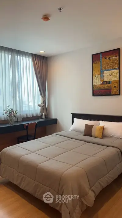 Cozy bedroom with modern decor and large window for natural light