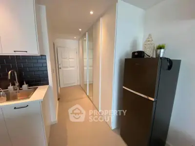 Modern kitchen with sleek black fridge and stylish backsplash