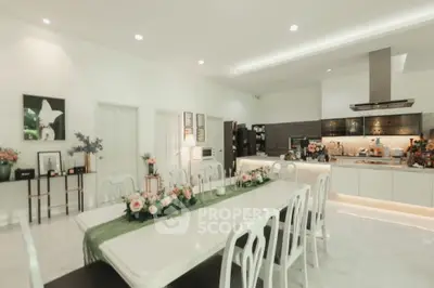 Luxurious open-layout kitchen with elegant dining area and modern appliances