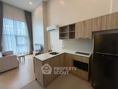 Modern open-layout kitchen with sleek appliances and cozy living area