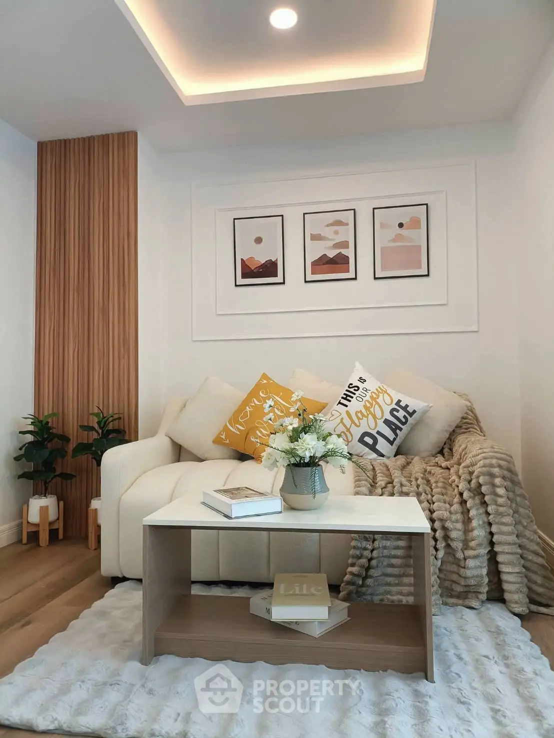 Cozy living room with modern decor, featuring a plush sofa, stylish coffee table, and elegant wall art.