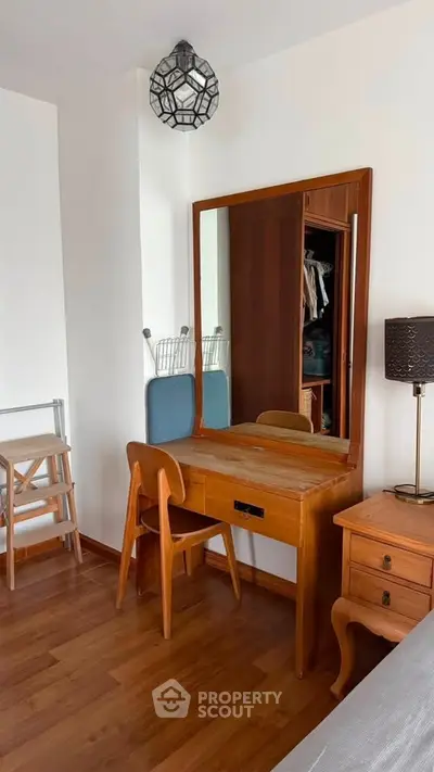 Charming bedroom with wooden furniture and stylish decor, perfect for a cozy and elegant living space.