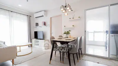 Modern living room with dining area and stylish lighting in a bright apartment.