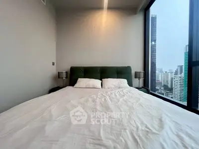 Modern bedroom with city view and large windows in high-rise apartment