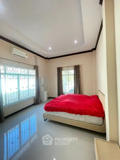 Spacious bedroom with large windows and modern design