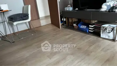 Modern living room with sleek wooden flooring and stylish furniture, perfect for contemporary living.