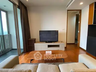 Modern living room with balcony access and sleek wooden flooring