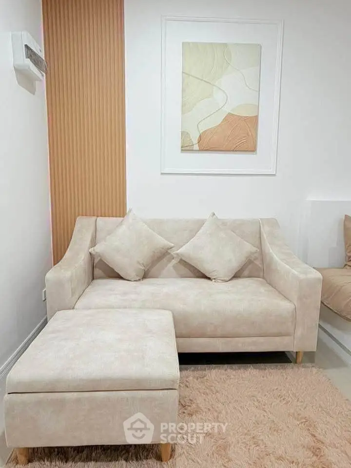 Cozy living room with modern beige sofa and abstract wall art