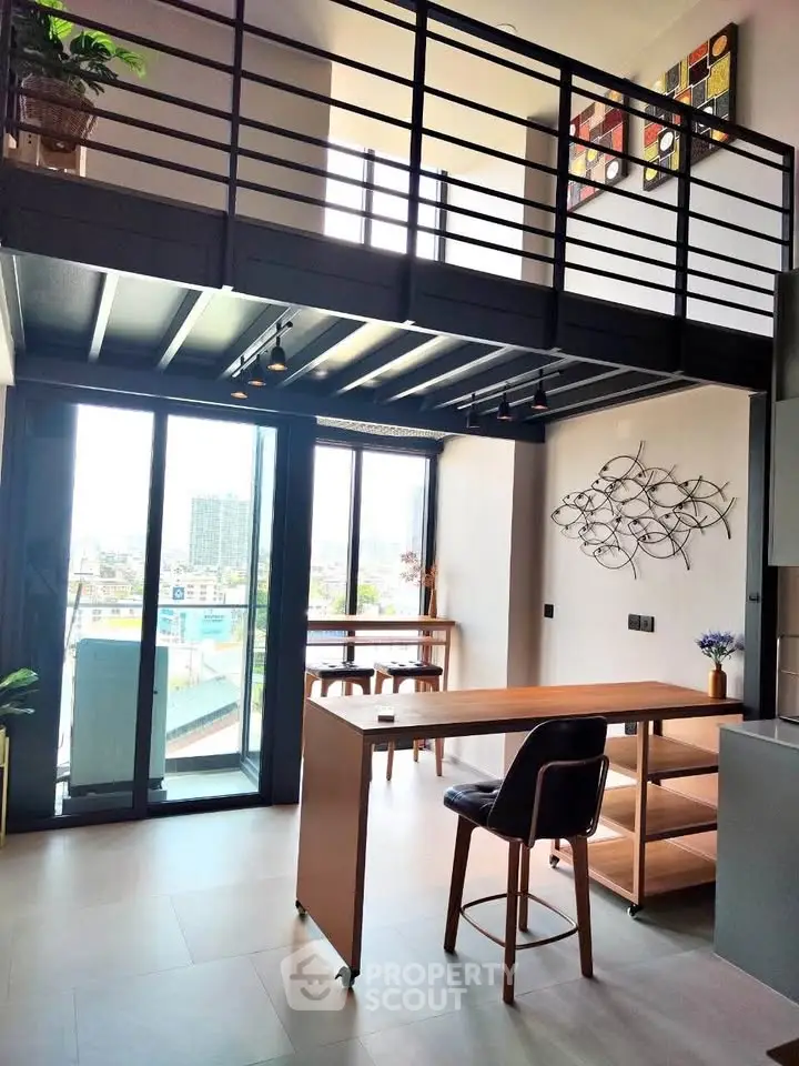 Modern loft apartment with mezzanine, large windows, and stylish interior design.