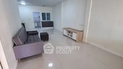 Spacious living room with modern sofa and sleek tile flooring