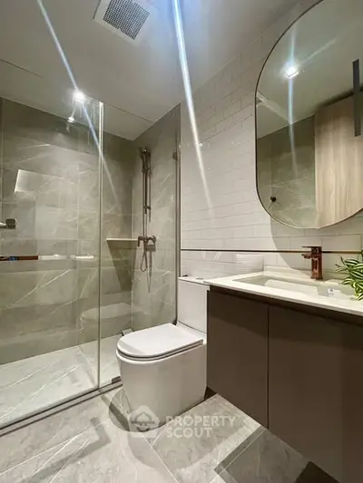 Modern bathroom with glass shower and stylish fixtures