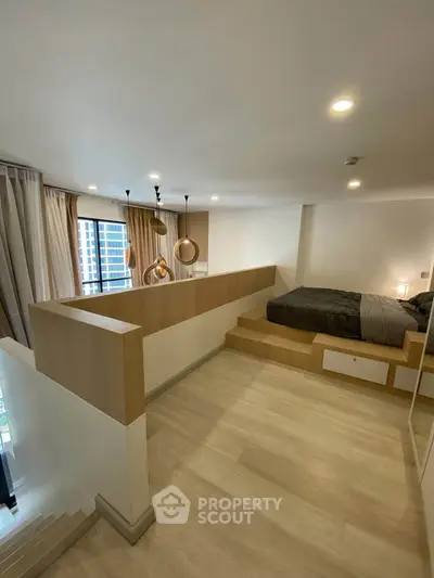Modern loft bedroom with stylish lighting and wooden flooring, offering a cozy and contemporary living space.
