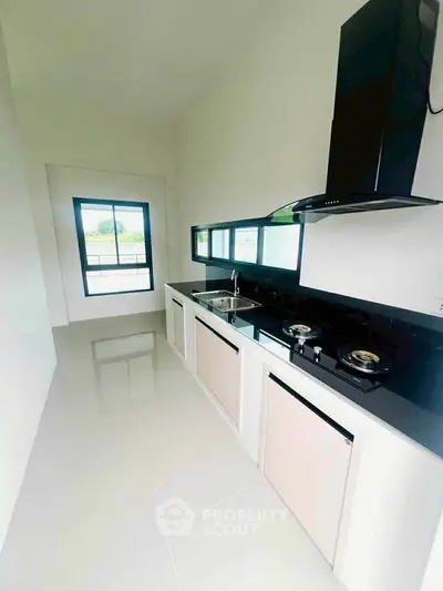 Sleek modern kitchen with gas stove and ample natural light