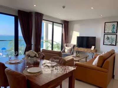 Stunning living room with ocean view, modern furniture, and elegant decor.