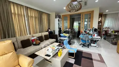 Spacious living room with modern decor and ample natural light, featuring comfortable seating and stylish furnishings.