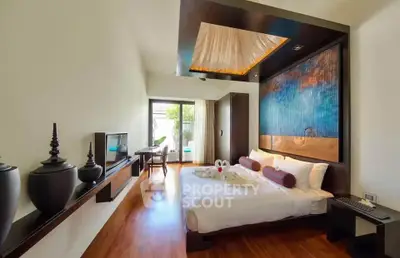 Luxurious bedroom with modern decor and pool view, featuring elegant wooden flooring and stylish furnishings.