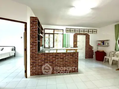 Charming open-layout kitchen with brick accents and modern decor