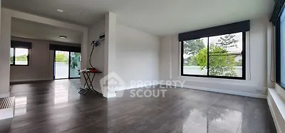 Spacious modern living room with large windows and sleek flooring